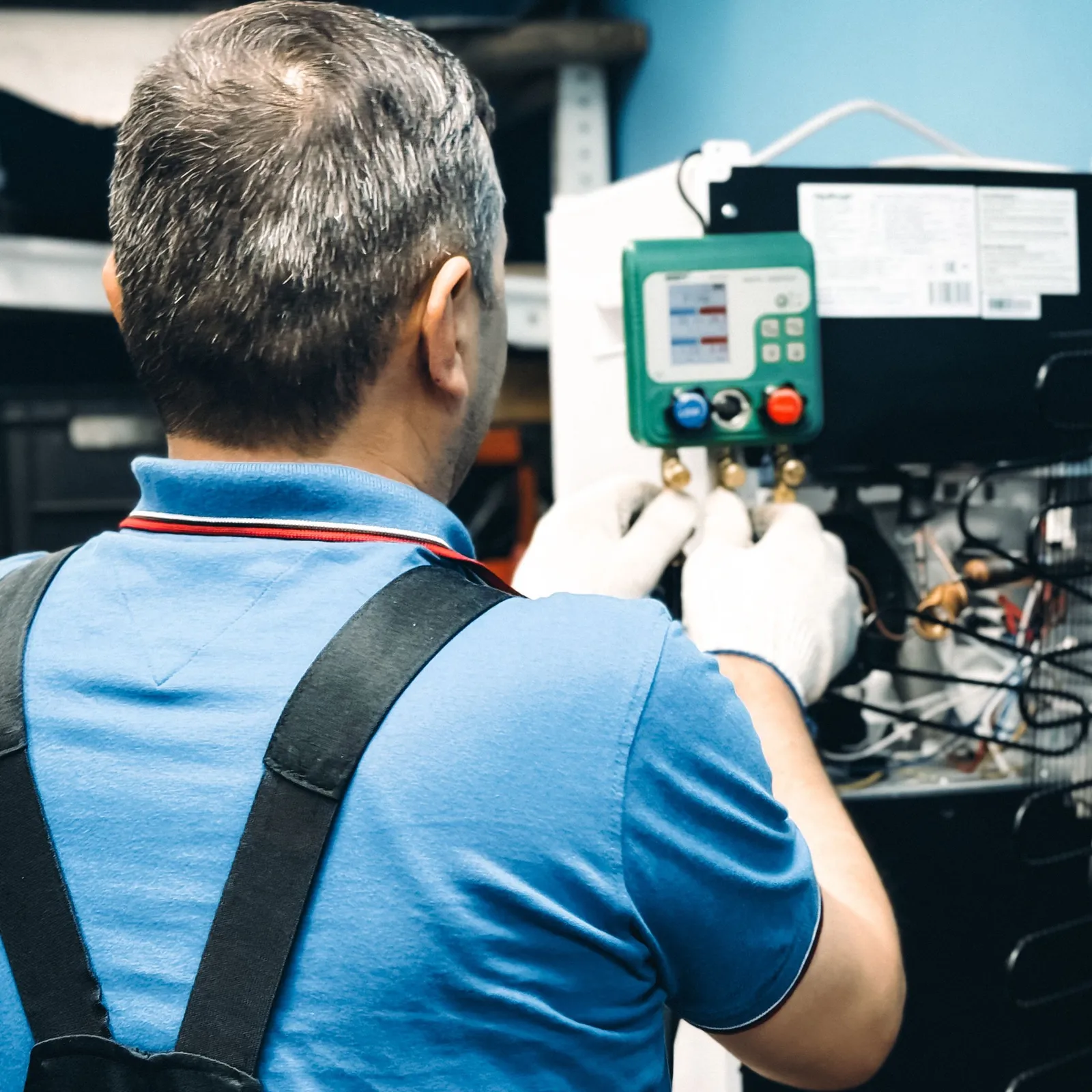 A technician performing air conditioning maintenance